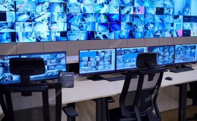 Security monitoring station with multiple screens and alarm indicators