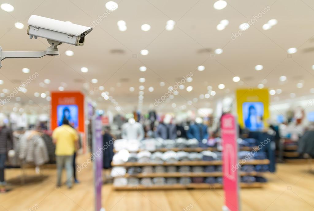 Retail shop interior with CCTV camera overlooking aisles